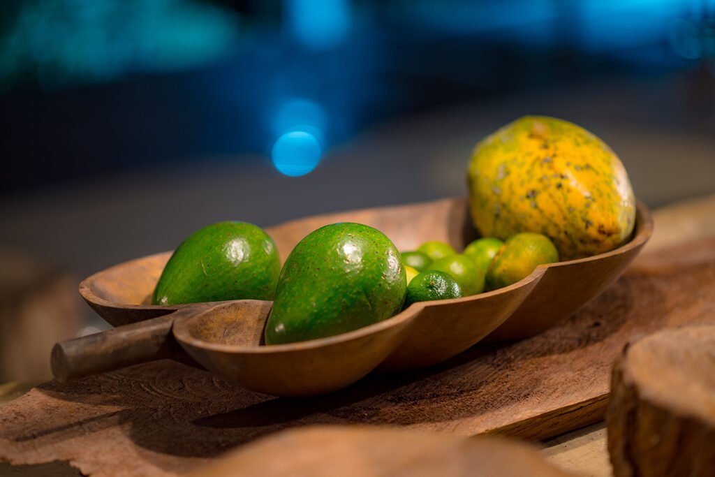 Frutas tropicales frescas en bandeja de madera rústica sobre mesa en Rivabella Eco Lodge, Boyacá.